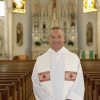 Why do priests wear white robes