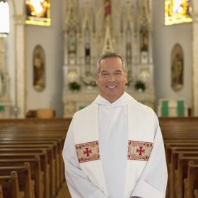 Why do priests wear white robes