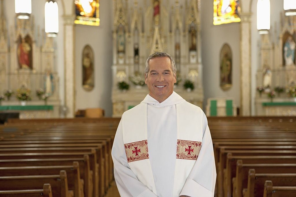 Why do priests wear white robes